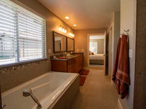 Ensuite bathroom featuring double vanity, a Separate soaking