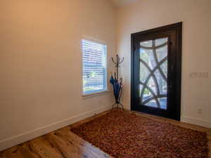 Foyer entrance featuring baseboards and wood finished floors