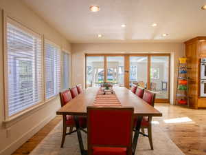 Dining area featuring french doors, recessed lighting, wood flooring,