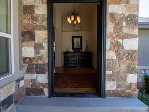 Formal entrance to property featuring stone siding
