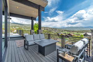 Deck with a mountain view and outdoor lounge area