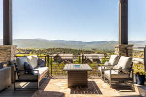 View of patio / terrace with a mountain view, outdoor lounge area, and a balcony