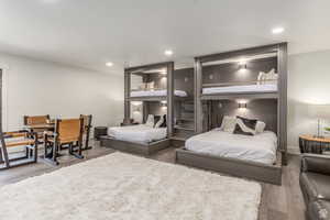 Bedroom with wood finished floors and recessed lighting