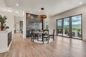 Dining room with light wood-type flooring, baseboards, and recessed lighting