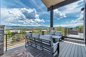 Wooden terrace with a mountain view and an outdoor living space
