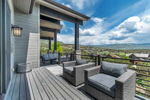 Deck with a mountain view and an outdoor living space