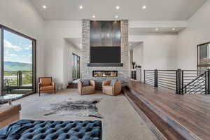 Living area featuring recessed lighting, a fireplace, a mountain view, and wood finished floors