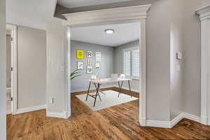 Office with wood finished floors and baseboards