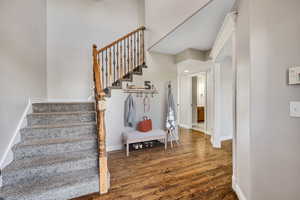 Staircase featuring wood finished floors and baseboards