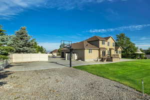 Rear view of property featuring driveway, stucco siding, and an attached garage