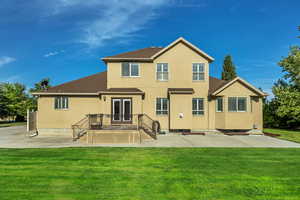 Back of property with stucco siding, french doors, a yard, and a patio