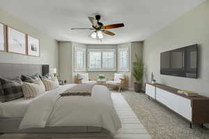 Carpeted bedroom featuring ceiling fan and baseboards
