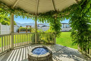 View of patio featuring a mountain view and an outdoor fire pit