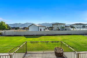 Deck with a residential view and a mountain view