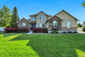 Traditional-style home with stucco siding and stone siding