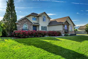 Traditional home with stucco siding, stone siding, and roof with shingles