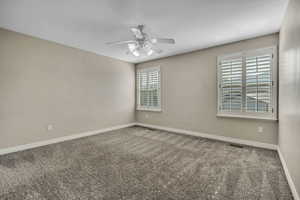 Unfurnished room featuring ceiling fan, carpet, and baseboards