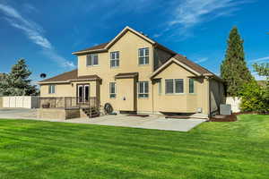 Rear view of house with stucco siding, a patio area, and central AC