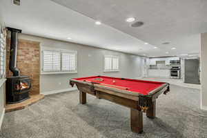 Playroom with light colored carpet, a wood stove, baseboards, billiards table, and recessed lighting