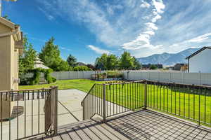 Wooden terrace featuring a mountain view and a patio