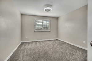 Unfurnished room with carpet and baseboards