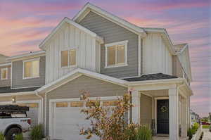 Townhome / multi-family property featuring board and batten siding and an attached garage
