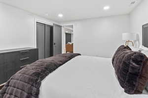 Bedroom featuring recessed lighting and a closet