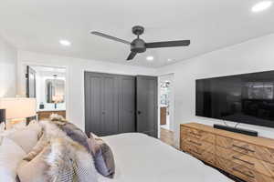 Bedroom with recessed lighting, connected bathroom, a ceiling fan, a closet, and wood finished floors