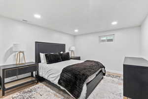 Bedroom featuring wood finished floors and recessed lighting