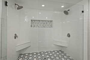 Full bath with tiled shower and recessed lighting