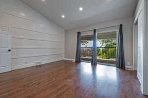 Empty room with dark wood finished floors, recessed lighting, lofted ceiling, baseboards, and built in features