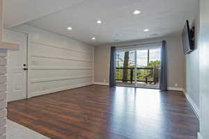 Spare room with dark wood finished floors, recessed lighting, and baseboards