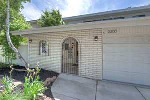 View of exterior entry featuring brick siding