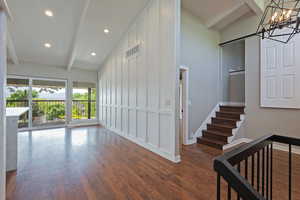 Stairs featuring beamed ceiling, baseboards, recessed lighting, wood finished floors, and a barn door