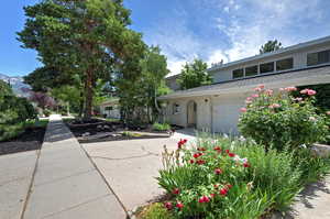 View of front of home featuring concrete driveway, a garage, brick siding, and a shingled roof