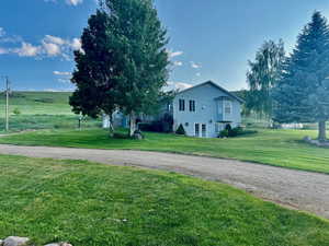 View of side of property with a lawn