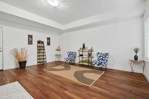 Sitting room featuring wood finished floors and baseboards