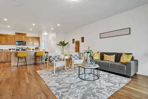 Living area featuring light wood-type flooring and recessed lighting
