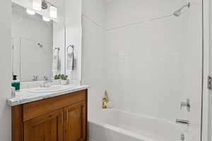 Bathroom with vanity and shower / washtub combination