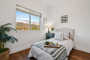 Bedroom featuring baseboards and wood finished floors