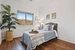 Bedroom featuring baseboards and wood finished floors