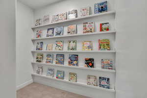 Detailed view of carpet flooring and baseboards