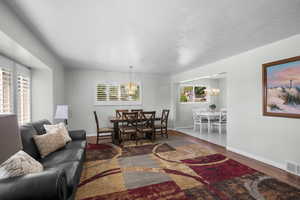 Spacious Living Room with Formal Dining Area and Lovely Chandelier! Plantation Shutters!