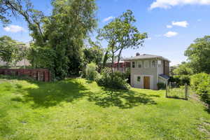 View of Back of House with Large Flat Grass Area!