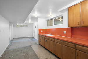 Large Kitchen and Dining Area are ready for your updates to complete this MIL or ADU unit!  It has Laundry Hook-ups and Opening to Family Room also, with Walkout to the Backyard! Includes frig (not shown)!