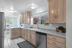 Light-filled Kitchen with Big Windows and Stainless Steel Appliances! The Stainless Steel Frig is included! Lots of Counterspace and Cabinets!