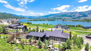 View from above of property with a water and mountain view
