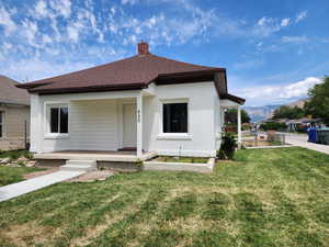Bungalow-style house with covered porch, a chimney, roof with shingles, and a mountain view