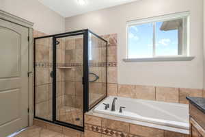 Full bathroom with a garden tub and a shower stall