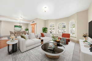 Living area featuring a chandelier and baseboards
